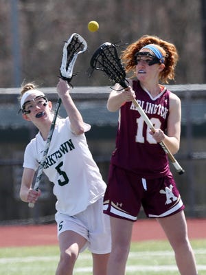 From left, Yorktown's Ciara Frawley (5)  and Arlington's Abby Carlin (10) battle for ball control during girls lacrosse action at Yorktown High School March 26, 2016. Yorktown won the game 14-5.