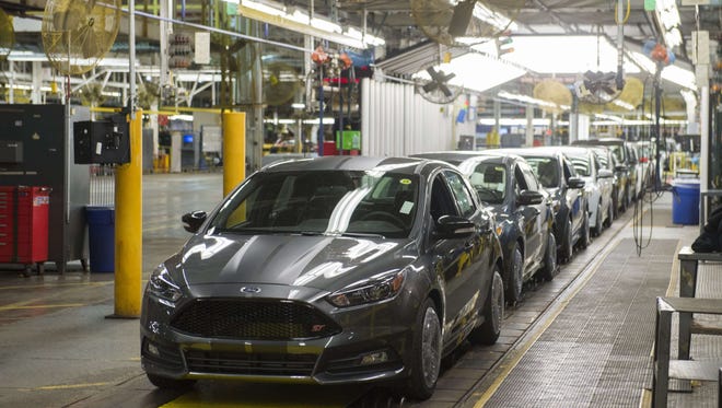 This January 7, 2015 file photo shows a lineup of Ford Focus vehicles on an assembly line at the Ford Michigan Assembly Plant in Wayne, Michigan.