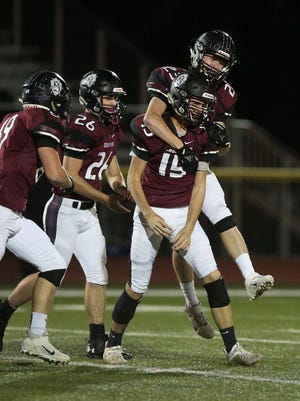 Buhler's Cody Wisecarver is congratulated by teammates after recovering the football during their game against Circle Friday night. Buhler defeated Circle 47-0.