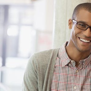 Man holding smartphone and smiling