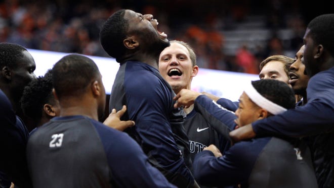 Monmouth's Sam Ibiezugbe, center, yells with teammates at the start of an NCAA college basketball game against Syracuse in Syracuse, N.Y., Friday, Nov. 18, 2016. (AP Photo/Nick Lisi)