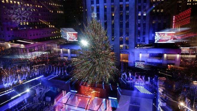The Rockefeller Center Christmas tree stands lit during the lighting ceremony, Wednesday, Dec. 2, 2015, in New York. The Norway Spruce tree is lit with about 45,000 multi-colored LED lights. (AP Photo/Julie Jacobson)