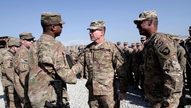 Lt. Gen. James McConville, center, visits troops in Afghanistan in 2013.