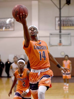 On a fast break, Callaway's Malik Newman (14) lays the ball up against the backboard for trailing teammate Marcus Summerville (2) on Monday, January 19, 2015, at Lanier High School. Newman had 32 of his 42 points in the first half.