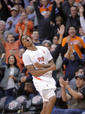 UTEP guard Omega Harris celebrates a three pointer against New Mexico State Saturday at the Don Haskins Center. 
