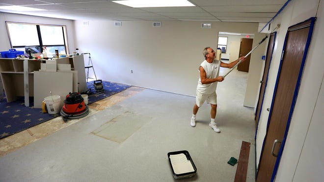 Steve Rogers paints the walls at the new Montessori Discover Academy at 875 Promontory Place SE, Wednesday, August 12, 2015, in Salem, Ore.