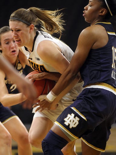 Iowa's Christina Buttenham fights off Notre Dame defenders