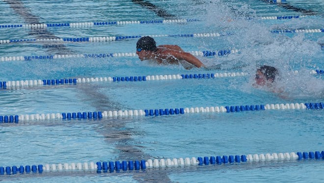 Cole Mitchell, 16, leads the 100 butterfly for the Granville Stingrays on Saturday during a meet against the Moundbuilders Piranhas at the Heath City Water Park.