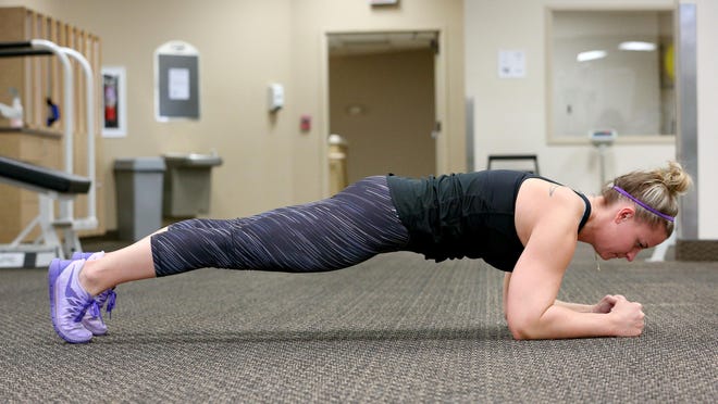 Katy Gates demonstrates a plank while working out at Courthouse Fitness in Keizer. Planks are a great way to work all four of the belly muscles in a safer manner.