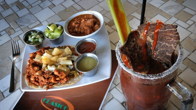 The Tacos al Pastor and the Norteño Clamato are popular menu items at Clasico Kitchen Bar, 9615 Montana.