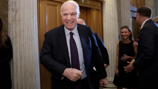 Sen. John McCain, R-Ariz., smiles as he arrives to vote on July 26, 2017, as the Republican-run Senate rejected a GOP proposal to scuttle President Barack Obama's health-care law.
