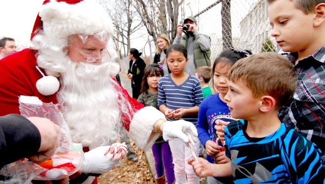 Santa greets Luke Manieri at Washington School during Nutley's 2015 Santa Ride.