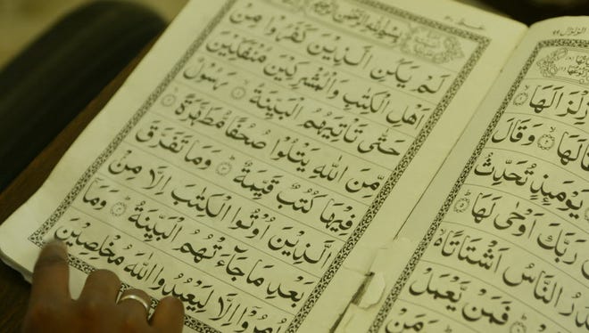 In this file photo, Muslim children read from the Koran.