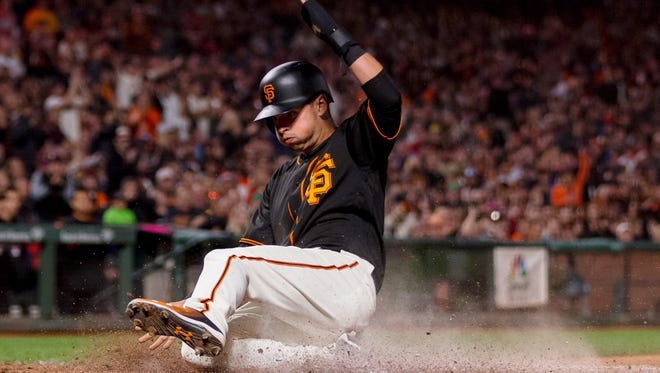 San Francisco Giants second baseman Joe Panik slides home to score against the Philadelphia Phillies in the eighth inning  Saturday at AT&T Park.