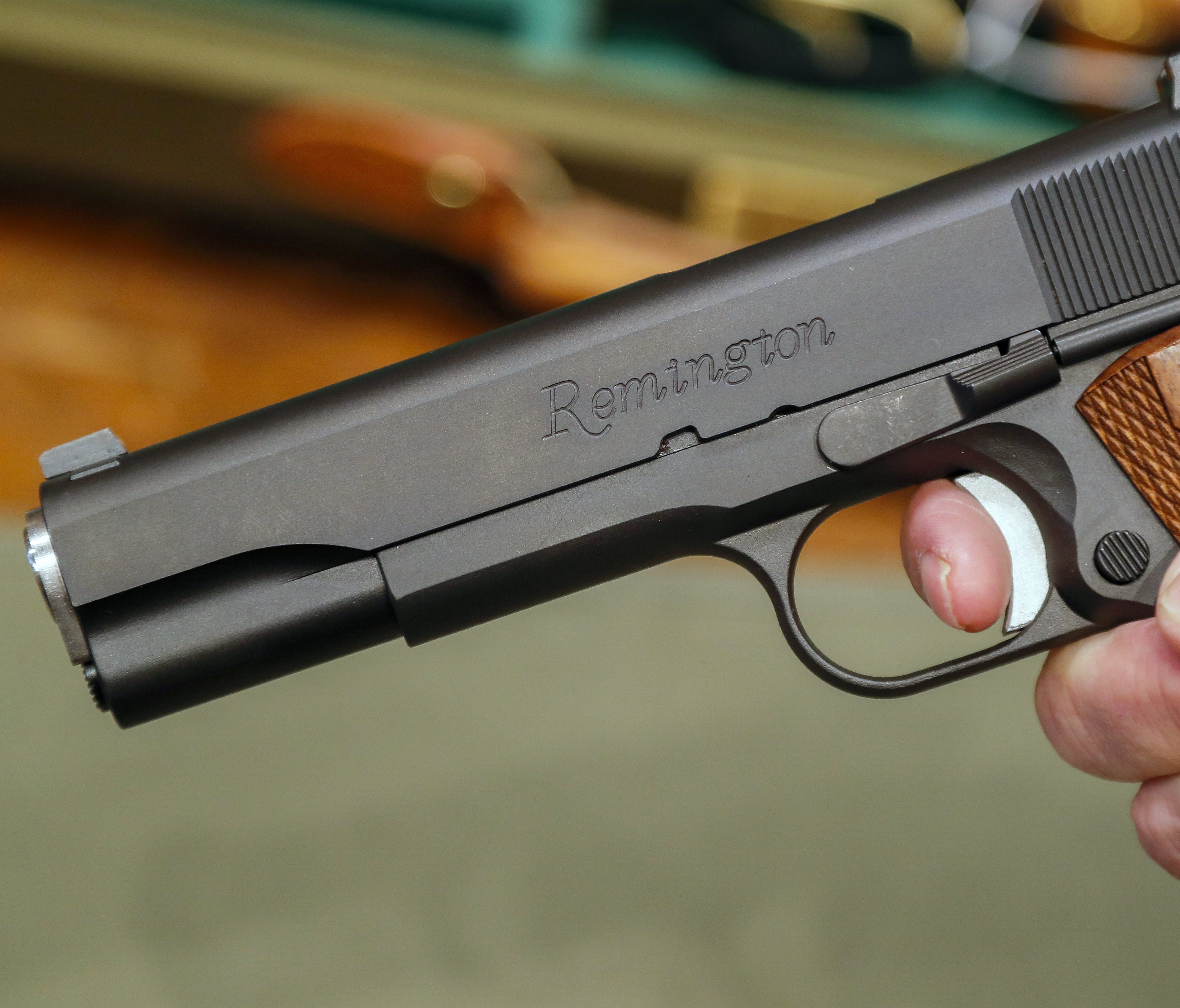 File picture: A salesperson holds a handgun at a firearms store.