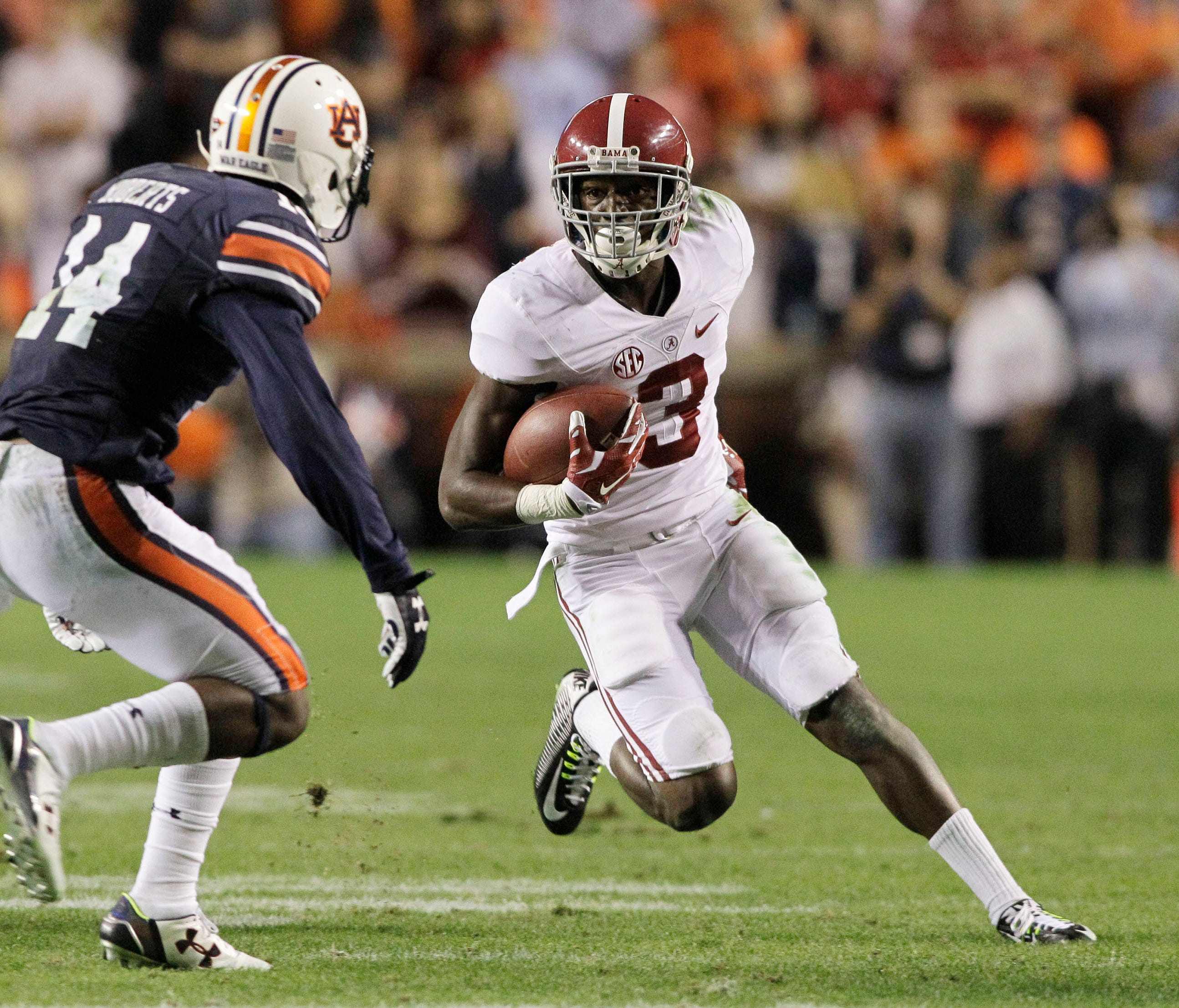 Alabama receiver Calvin Ridley avoids Auburn  defensive back Stephen Roberts during their game in 2015.