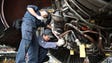 Mechanics work on a engine of a Boeing 747 inside