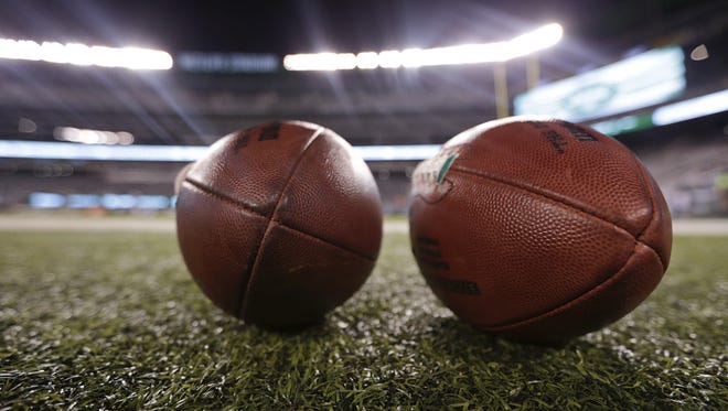 NFL footballs sit on the sidelines before an NFL football game between the New York Jets and the Chicago Bears, Monday, Sept. 22, 2014, in East Rutherford, N.J. (AP Photo/Julio Cortez)