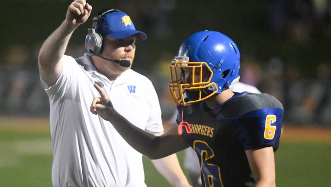 Westview head football coach Trey Cantrell holds up his index finger as his player Westview's Riley Cormia heads out for a field goal during their game against Dresden, Thursday, Aug. 17.