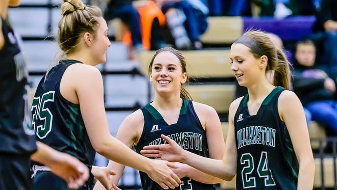 Kenzie Lewis ,24, and Maddie Watters ,center, of Williamston congraulate their teammate Allison Peplowski ,left, after she is fouled early in the 4th quarter of their Class B district championship game with Williamston holding a 48-23 lead over Fowlerville Friday March 3, 2017 in Fowlerville.  KEVIN W. FOWLER PHOTO