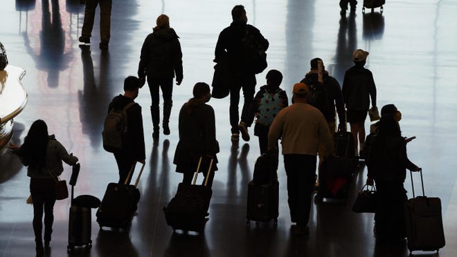 Travelers walk through the Salt Lake City International Airport on Wednesday, Nov. 25, 2020.