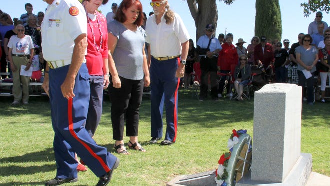 Blue Star Mothers, Pamela Sweetser, left and Liz Ferrell placed a wreath at the grave site of the Deming and Luna County military service men and women who made the ultimate sacrifice during Monday's Memorial Day ceremony at Mountain View Cemetery in Deming, NM.