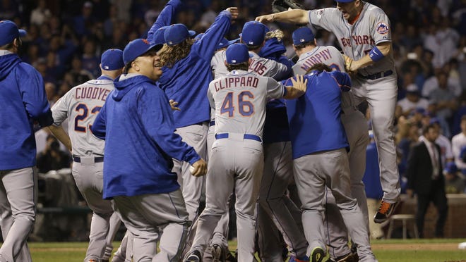 The New York Mets celebrate after Game 4 of the National League baseball championship series against the Chicago Cubs Wednesday, Oct. 21, 2015, in Chicago. The Mets won 8-3 to advance to the World Series.