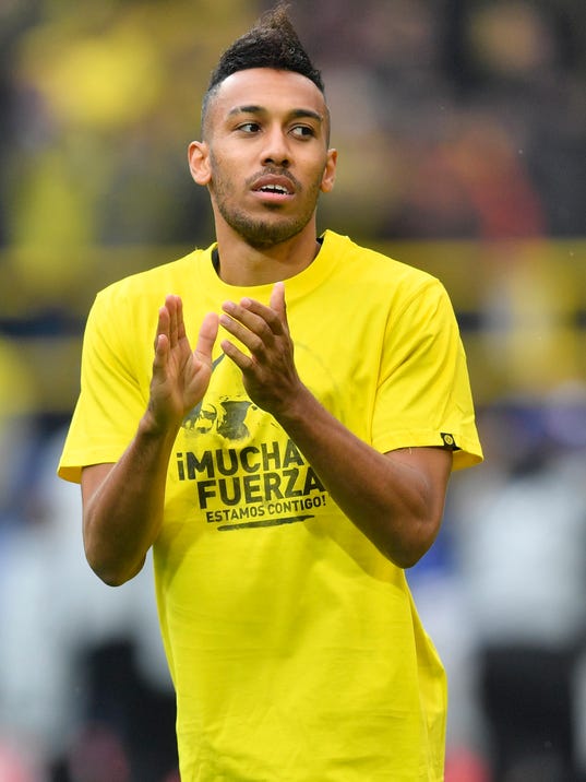 Dortmund's Pierre-Emerick Aubameyang wears a t-shirt 'A lot of strength - we are with you" for his teammate Marc Bartra who was injured after an explosion the day before as he warms up prior to the Champions League quarterfinal irst leg soccer match between Borussia Dortmund and AS Monaco in Dortmund, Germany, Wednesday, April 12, 2017. (AP Photo/Martin Meissner)