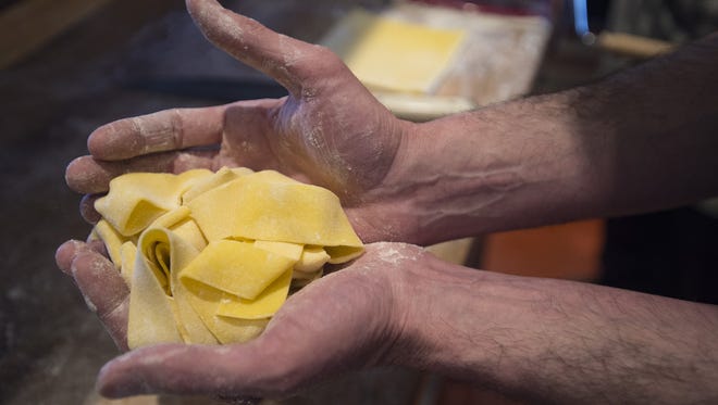 Executive Chef Brian Shaner shows off a freshly rolled serving of pappardelle pasta in the kitchen at Nick's Italian on College Avenue on Friday, February 2, 2018.