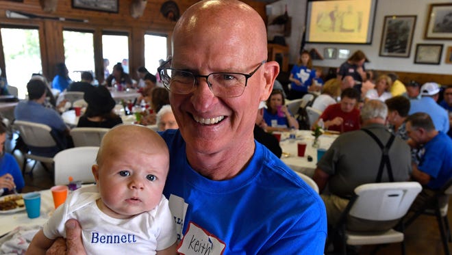 Keith Gilbert holds his grandson Bennett, a fourth-generation member of the family that started with Hiram and Belle Bennett in the early 20th century. Gilbert and about 130 others celebrated Claude's Day June 10 at Stasney's Cook Ranch near Albany. The annual family reunion was begun when Claude Bennett returned home to Jones County after World War I in 1919.