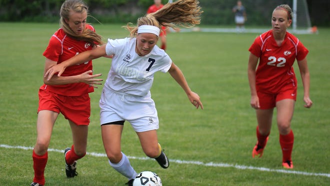 Dribbling past Canton’s Mary Galm (left) is Saline’s Taylor Mulder, who scored her 41st goal of the season Friday. At right for the Chiefs is Rachel McGue.