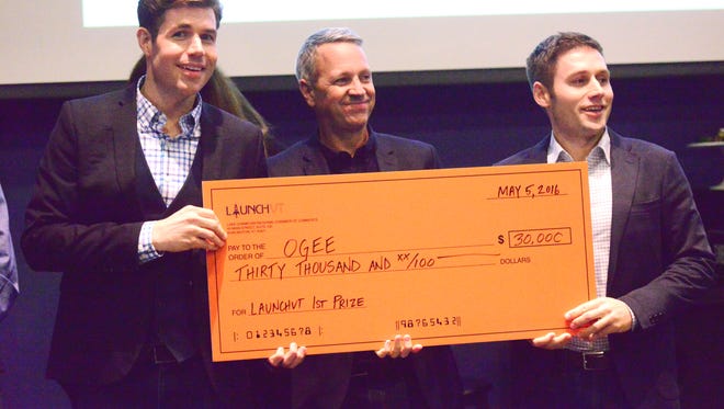 Ogee principals Abott Stark, left, Mark Rice and Alex Stark, accept the first-place award at the LaunchVT contest.