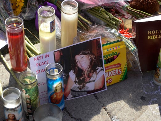 Mementos, candles and flowers are left at a makeshift