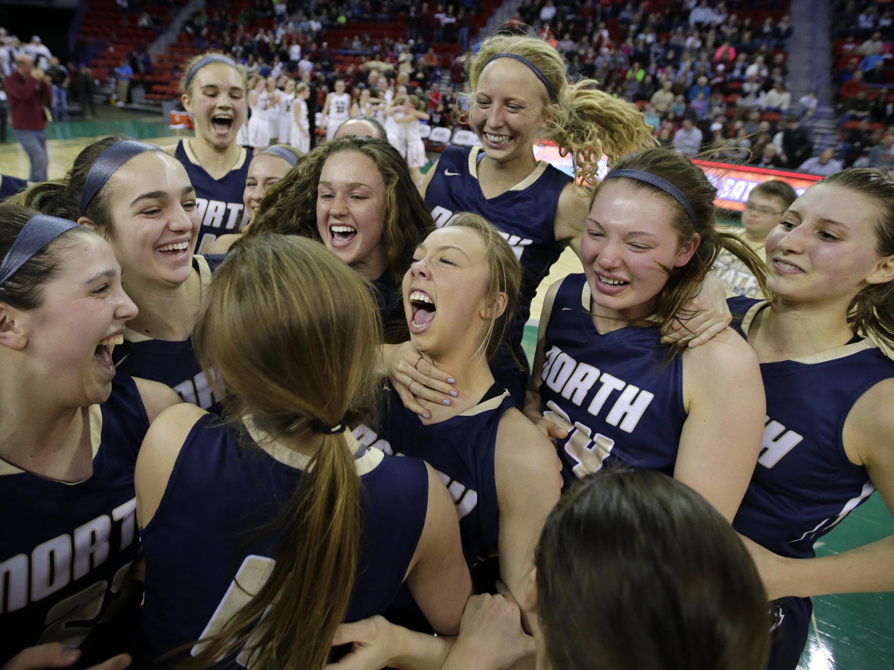 Appleton North players celebrate their victory against De Pere in the WIAA Division 1 girls’ basketball state championship game Saturday at the Resch Center in Ashwaubenon. It is the first state title for North, which finished the season undefeated.