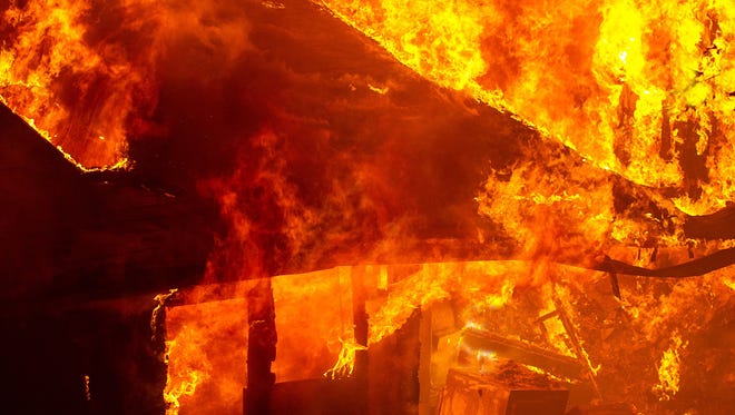 A house is engulfed in flames in this file photo.