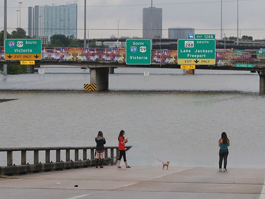 TOPSHOT - People view the flooded highways in Houston