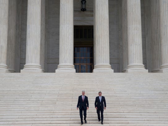 Justice 
Neil Gorsuch descends the steps of the Supreme