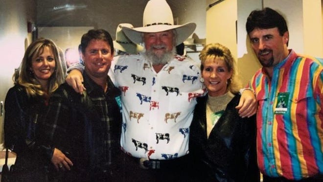 Charlie Daniels, center, poses with Andy Petree and his wife Patty and Steve Barkdoll, far right, and his late wife, Lynn, in this photo at a concert at Harrah's Cherokee Casino in 2000.