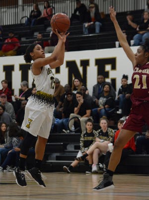 Abilene High's Triniti Wilson shoots a pull-up jumper over Keller Central's Lauryn Daigle during the Lady Eagles' 57-49 win Friday at Eagle Gym.
