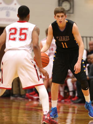 Carmel's Ryan Cline moves the ball up the court at Lawrence North Friday February 6, 2015. Carmel won 52-49.