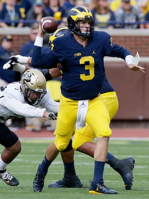 Quarterback Wilton Speight of the Michigan Wolverines is pressured by Rick Gamboa of the Colorado Buffaloes while trying to pass the ball during the first half at Michigan Stadium on September 17, 2016 in Ann Arbor, Michigan.