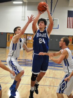 Highlands quarterback Austin Hergott, shown playing basketball for the Bluebirds in the winter, committed to Central Michigan University on Monday night.