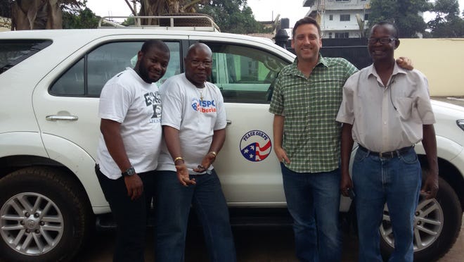 Baltimore native Kevin Fleming, third from left, stands with other staff members from the Peace Corps office Fleming works at in Liberia.