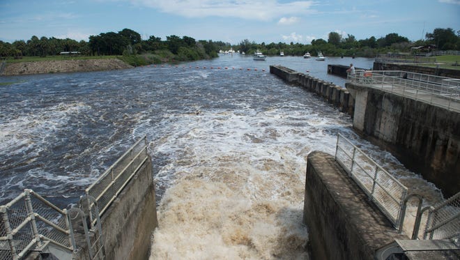 Water from Lake Okeechobee is discharged through the St. Lucie Lock and Dam on Wednesday, Sept. 6, 2017 in Stuart. 