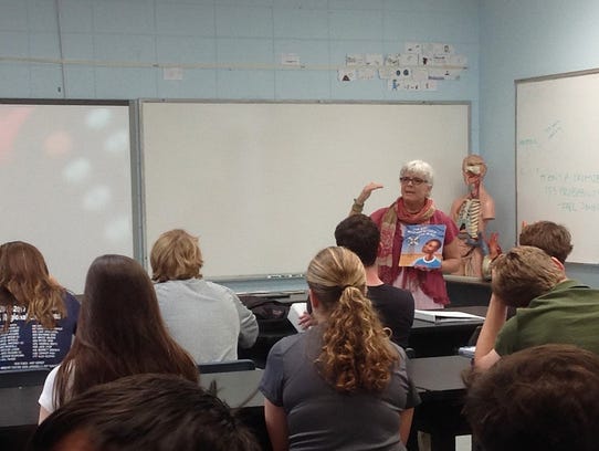 Lisa Vihos speaks to a high school ecology class at