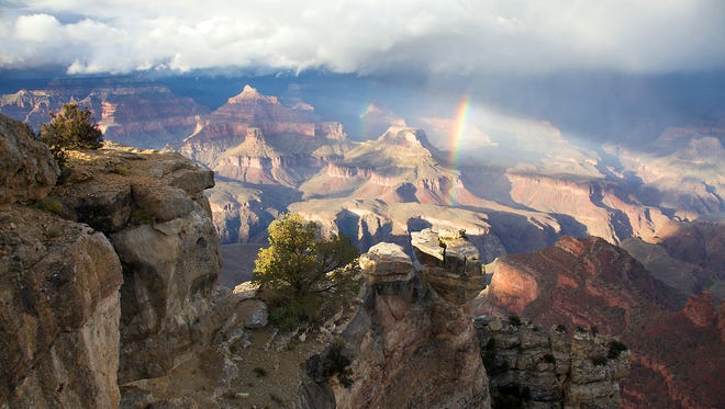 The last rays of sunshine catch a rainbow above Maricopa Point on the South Rim of the Grand Canyon.
