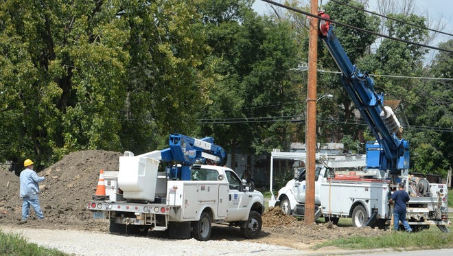RP&L workers install a utility pole on North West Fifth Street in Richmond.