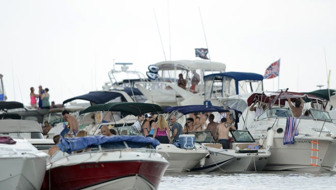 Boats large and small anchor together in 2013 during the annual Jobbie Nooner boat party around Gull Island south of Harsens Island. Authorities were searching Saturday for a man who went missing following this year's bash.
