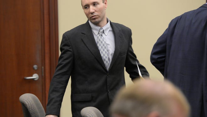 John Kelsey looks back toward the courtroom after being found guilty in June on two charges in connection with a fatal police chase in December that resulted in the death of Ingham County Sheriff’s Deputy Grant Whitaker.