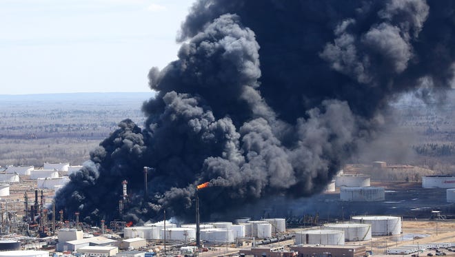 Thick smoke pours from the fire at the Husky Energy oil refinery in Superior, Wis., Thursday afternoon.